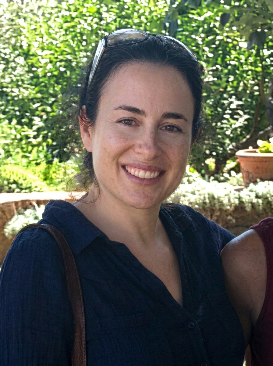 Black haired woman smiling at camera